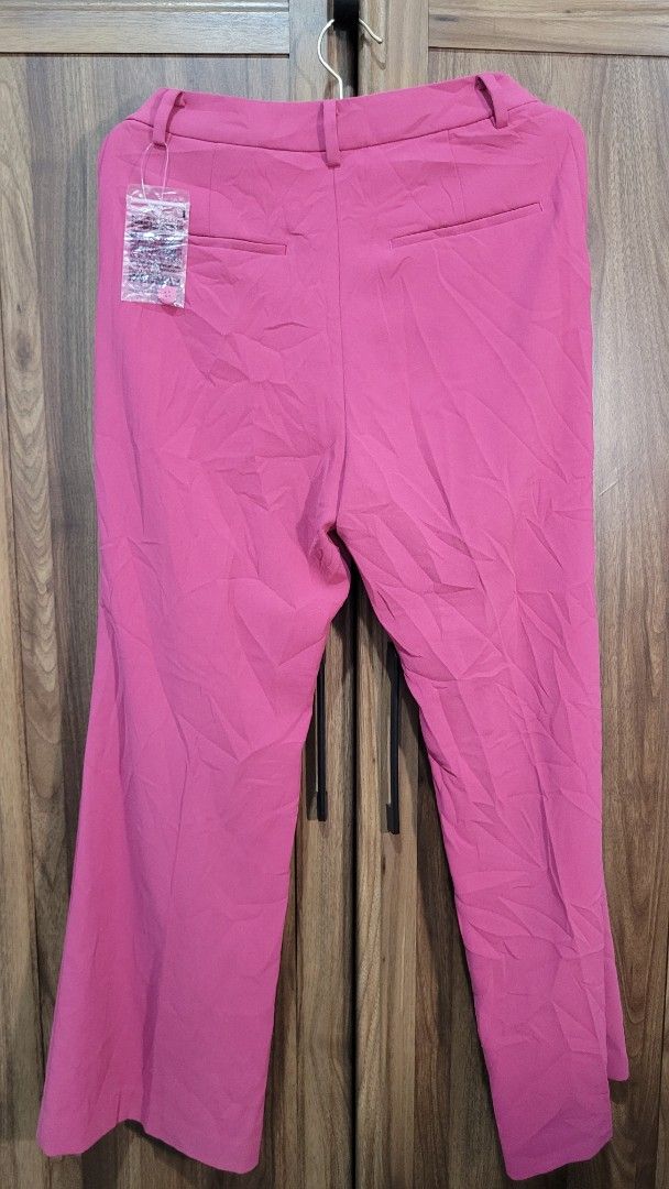 Uniqlo Drape Flared Pants - Pink (Category: Other Bottoms) located in Davao. Submitted by NearlyNew (Listing ID 1447507456, Image 3). Description: - Brand new Uniqlo Drape Flared Pants - Color: Pink - Size: 155/62A (Waist 61cm, Hip 88cm) - Material: 100% Polyester - Design: Flared leg - Versatile: Great for casual or dressy outfits - Condition: Brand new, no tag, extra buttons - Best fits XS to S.