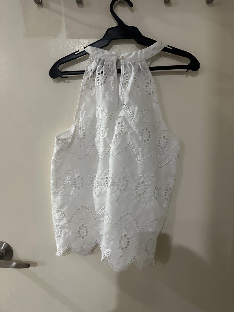 White Eyelet Halter Neck Sleeveless Top (Category: Sleeveless) located in Manila. Submitted by bellevd (Listing ID 1447547856, Image 2). Description: - White sleeveless top - Delicate eyelet details - Flattering scalloped hemline - Elegant high halter neckline - Convenient button closure at the back neck - Versatile: pairs well with shorts or skirts - Suitable for casual or dressed-up occasions.