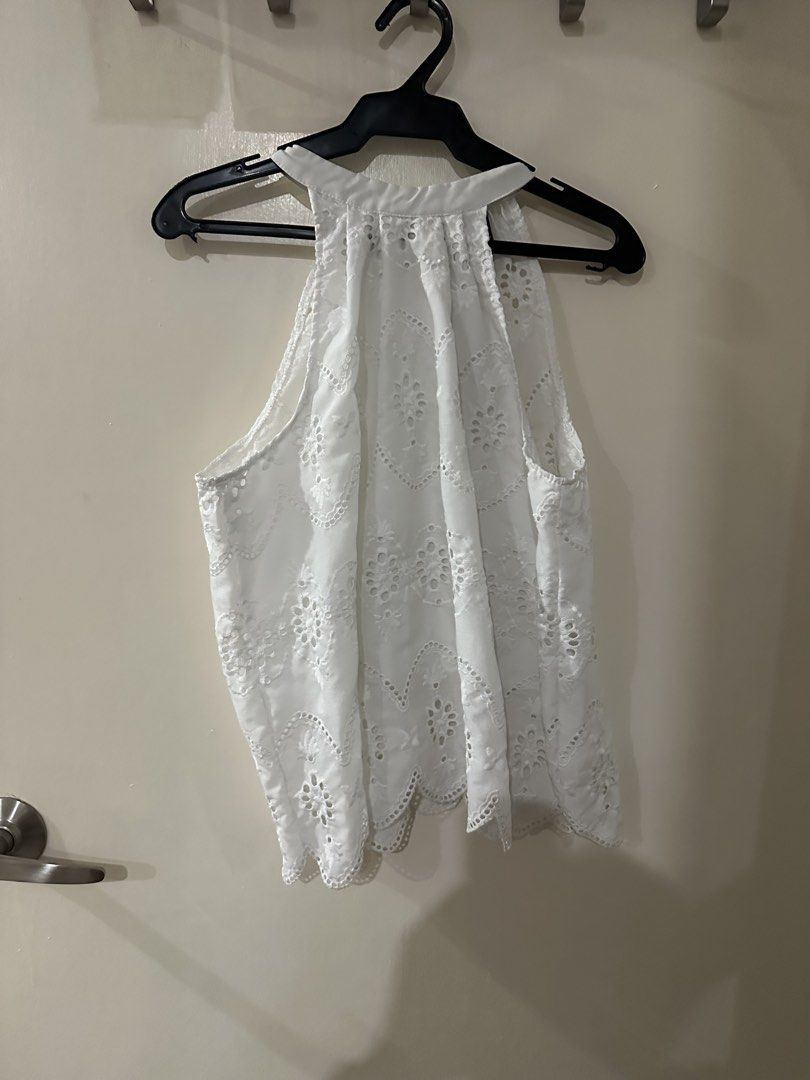 White Eyelet Halter Neck Sleeveless Top (Category: Sleeveless) located in Manila. Submitted by bellevd (Listing ID 1447547856, Image 1). Description: - White sleeveless top - Delicate eyelet details - Flattering scalloped hemline - Elegant high halter neckline - Convenient button closure at the back neck - Versatile: pairs well with shorts or skirts - Suitable for casual or dressed-up occasions.