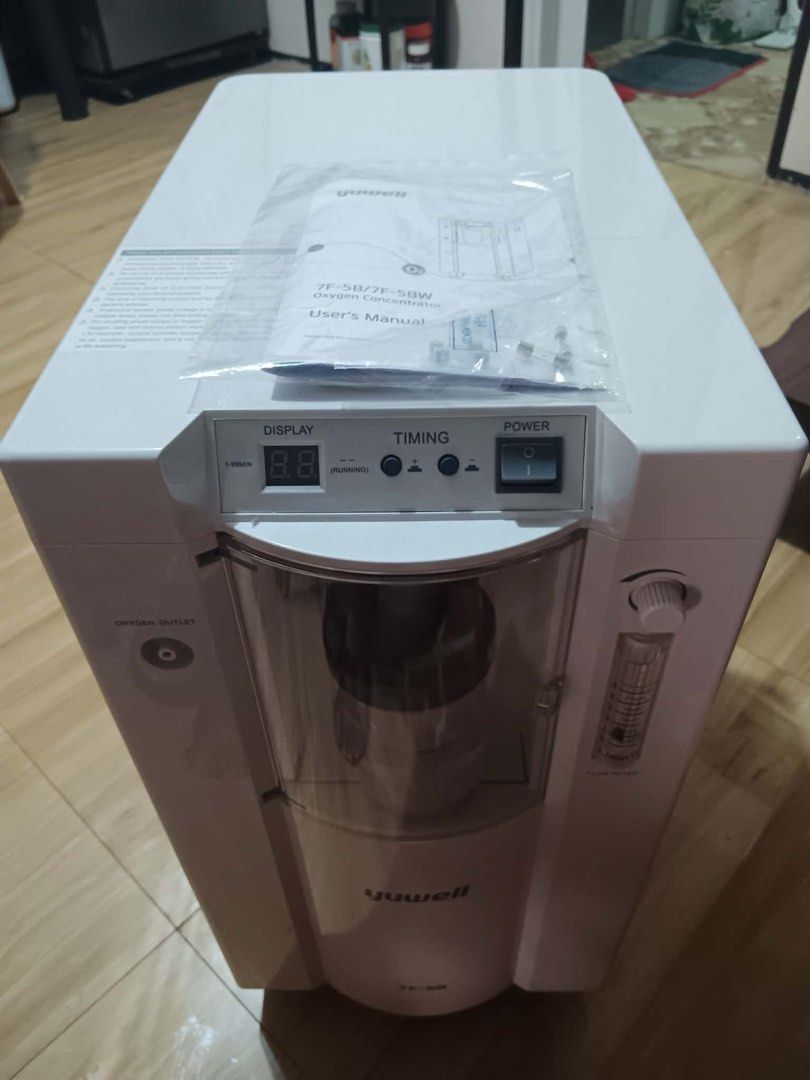 Yuwell Oxygen Concentrator 7F-5B/7E-5BW (Category: Medical Supplies & Tools) located in Taguig. Submitted by nazthings (Listing ID 1447620509, Image 2). Description: - Yuwell Oxygen Concentrator - Model: 7F-5B / 7E-5BW - Color: White - Features: Display, Timing Function - Includes: User Manual, Water Bottle - Design: On wheels for easy mobility - Controls: Power button on top, Oxygen outlet on side - Condition: Ready for pickup bulacan area .