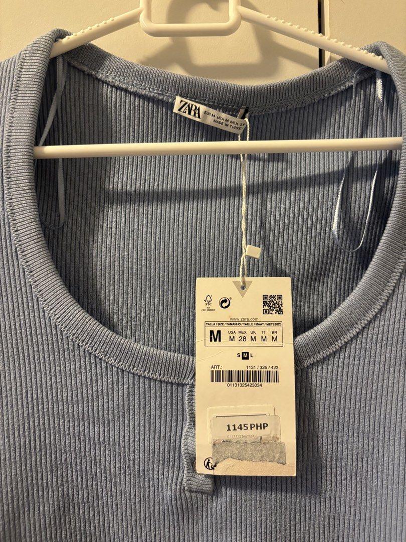ZARA Ribbed Cropped Top with Buttons - Blue (Category: Blouses) located in Makati City. Submitted by shariesg (Listing ID 1447520415, Image 2). Description: - ZARA Blue Ribbed Cropped Top - Size: Medium (M) - Style: Short sleeves, scoop neckline with button details - Condition: Brand new with tags attached - Perfect for: Casual wear or dressing up.