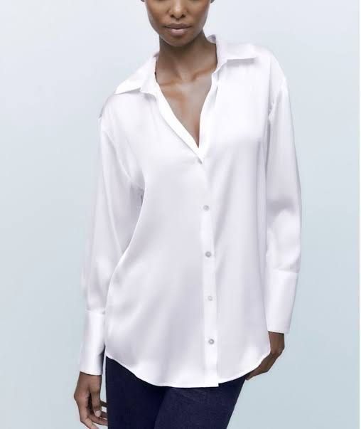 Zara White Button-Up Shirt XS (Category: Shirts) located in Silang. Submitted by xoxovintage98 (Listing ID 1440768473, Image 1). Description: - Brand: Zara - Type: Button-up Shirt - Color: White - Size: XS - Features: Long sleeves with button cuffs, classic collar - Fit: Slightly oversized - Condition: New with original tags attached - Versatility: Great for casual or work wear.
