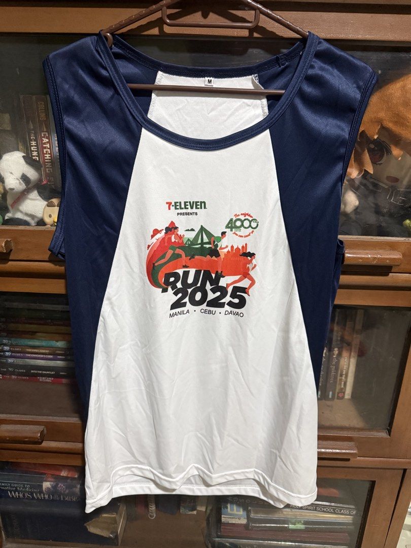 7-Eleven Run 2025 Race Singlet (Medium) (Category: Activewear) located in Quezon City. Submitted by halpharagus (Listing ID 1447830370, Image 1). Description: - Sleeveless running shirt from the 7-Eleven Run 2025 event. - Features the official event logo. - Includes locations: Manila, Cebu, and Davao. - Color: Navy Blue and White. - Size: Medium. - Ideal for races or everyday casual wear..
