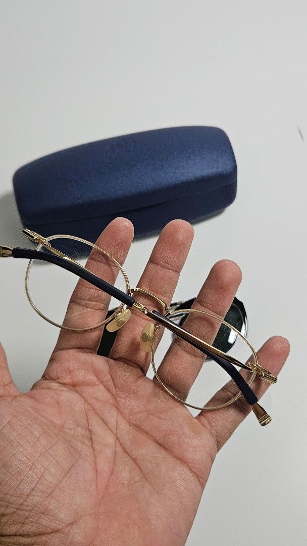 999.9 four nines Titanium Eyeglasses (Category: Sunglasses & Eyewear) located in Alfonso. Submitted by jbcamet (Listing ID 1447812782, Image 2). Description: - Lightweight titanium frame with elegant gold rims -S-145T - Includes clip-on dark sunglasses for sun protection - Durable and comfortable for everyday wear - Comes with a stylish navy blue protective case.