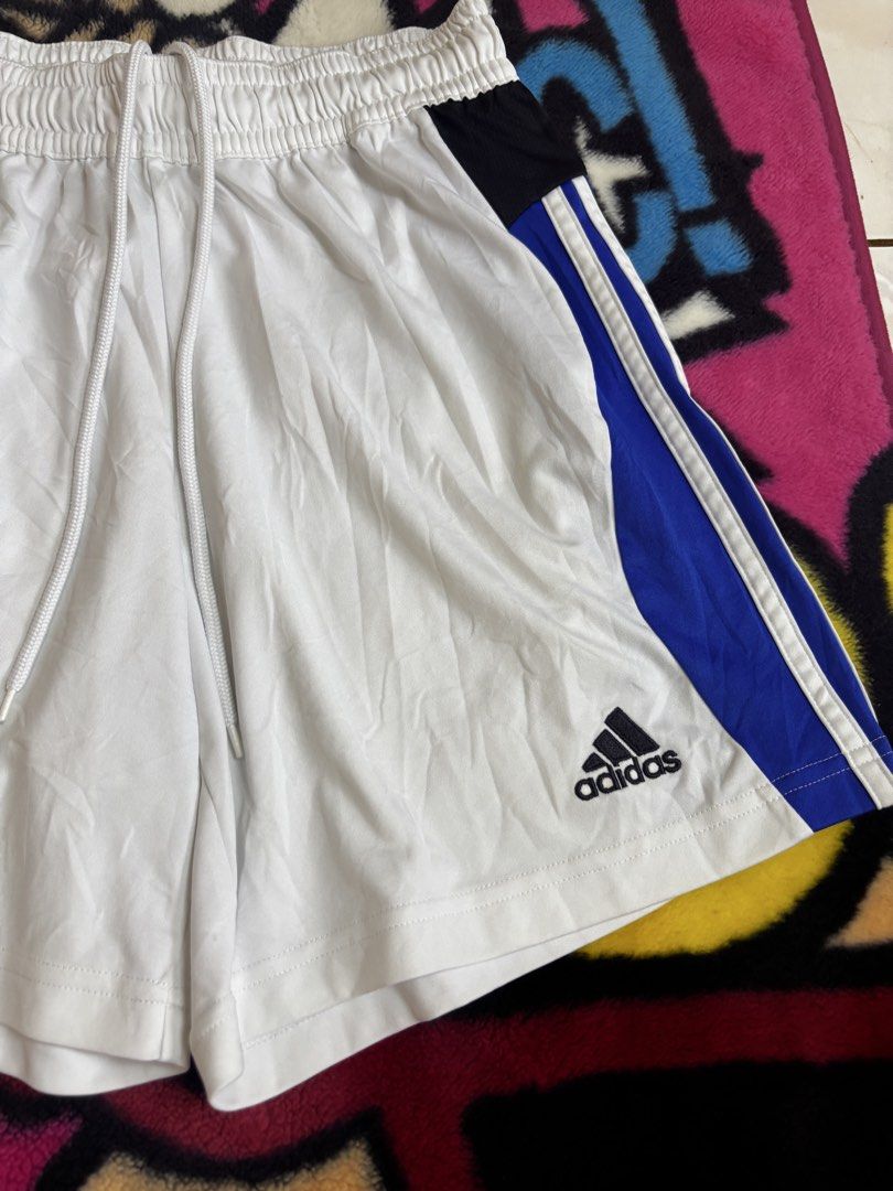 Adidas jersey Climacool shorts (Category: Shorts) located in Andop. Submitted by ukaylangpo (Listing ID 1447725357, Image 2). Description: - White Adidas basketball shorts - Blue and black accent details - Iconic 3-stripes on the sides - Large '5' graphic - Elastic waistband with drawstring for adjustable fit - Climalite technology for moisture-wicking comfort - Ideal for basketball, sports, or everyday casual wear.