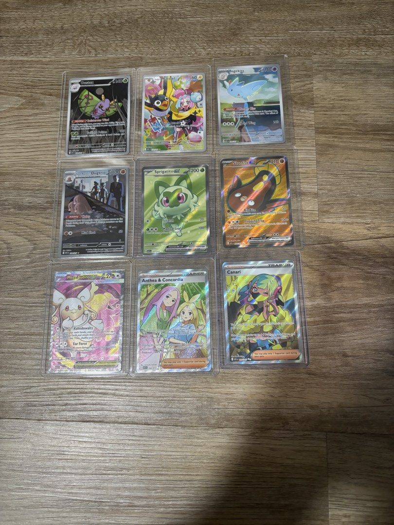 Assorted Pokémon cards (Category: Raw Cards) located in Singapore. Submitted by atreus (Listing ID 1447683085, Image 1). Description: - Selling the following cards: - Dustox #220 $4 - Iono Wattrel #231 $12 - Togekiss #235 $7 - Team Rocket Dugtrio #239 $15 - Sprigatito #251 $3 - Stunfisk Ex #252 $1 - Mega Audino Ex #253 $1 - Anthea & Concordia #254 $2 - Canari #257 $4 - slight nego for fast deal - Excellent additions for collectors - All cards kep