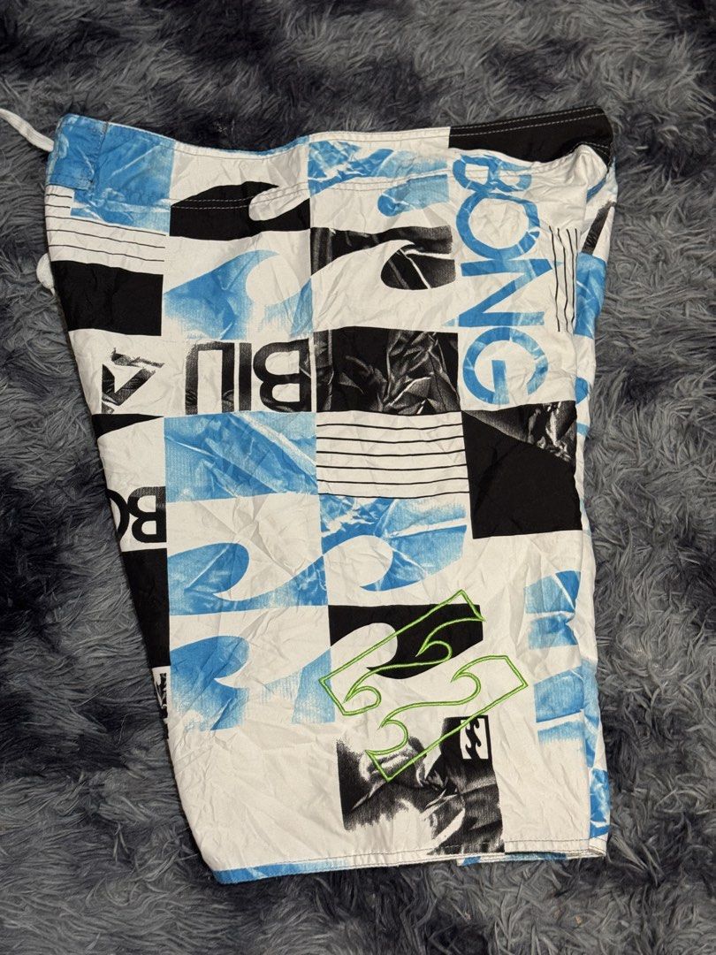 Billabong Board Shorts Size 36 (Category: Swim Trunks & Board Shorts) located in Manila. Submitted by keithanced50261 (Listing ID 1447680788, Image 3). Description: - Brand: Billabong - Size: 36x22 - Design: Checkered and wave pattern with "BILLABONG" text graphics .