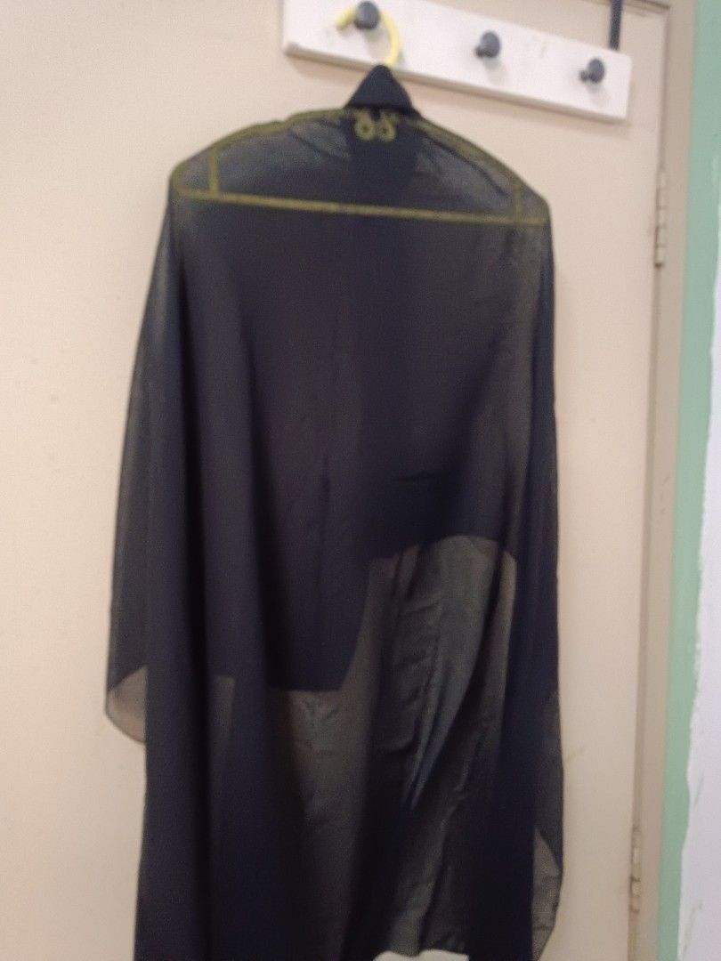 Black Shawl (Category: Hijabs) located in Petaling Jaya. Submitted by farisamri03 (Listing ID 1447683461, Image 1). Description: Elegant black shawl. It is draped over a hanger. The color is a deep black, suitable for various occasions. The shawl is long and flowing..