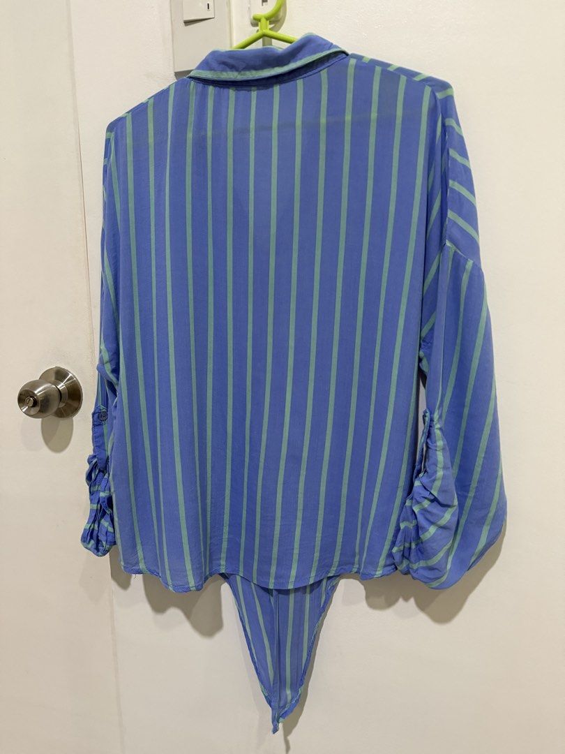 Blue Striped Rayon Button Down Polo Blouse Long Sleeve Oversized M (Category: Blouses) located in Caloocan City. Submitted by tee-hee-vintage (Listing ID 1447757719, Image 2). Description: Stay comfortable and stylish with this lightweight 100% rayon button-down blouse. Features a relaxed fit with vertical stripes that create a slimming look, a collared neckline, chest pocket, and roll-tab sleeves for versatile styling..