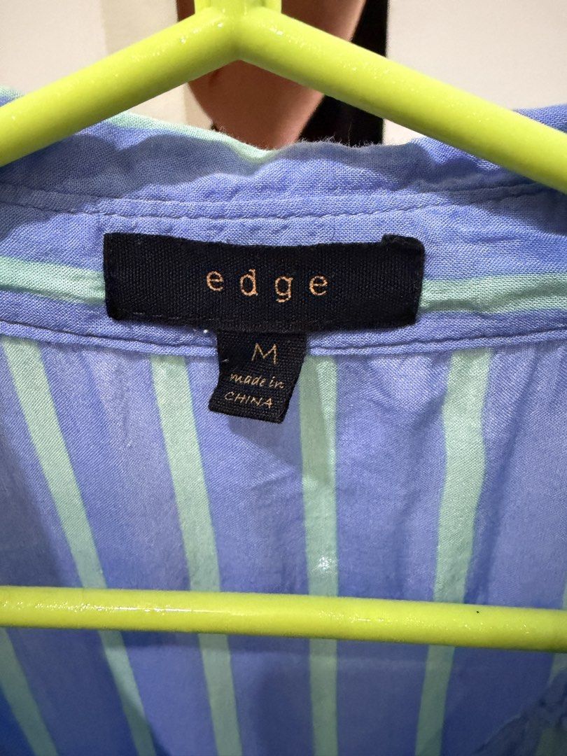 Blue Striped Rayon Button Down Polo Blouse Long Sleeve Oversized M (Category: Blouses) located in Caloocan City. Submitted by tee-hee-vintage (Listing ID 1447757719, Image 3). Description: Stay comfortable and stylish with this lightweight 100% rayon button-down blouse. Features a relaxed fit with vertical stripes that create a slimming look, a collared neckline, chest pocket, and roll-tab sleeves for versatile styling..