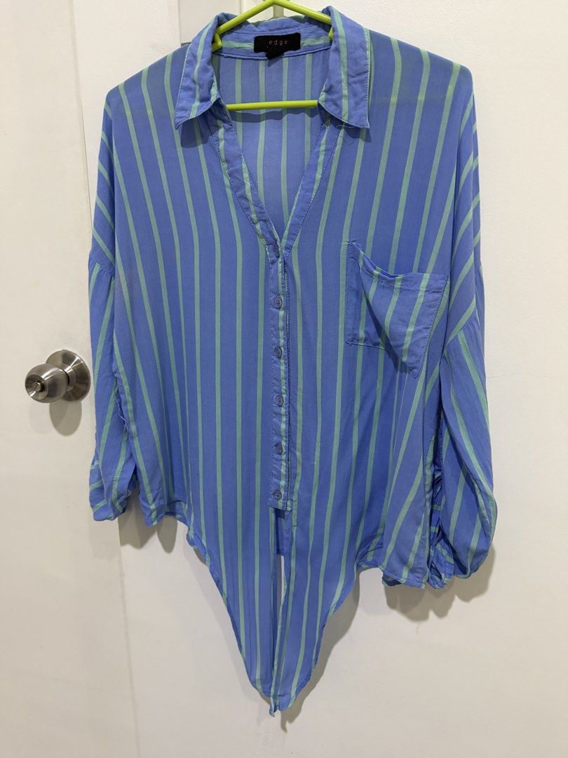 Blue Striped Rayon Button Down Polo Blouse Long Sleeve Oversized M (Category: Blouses) located in Caloocan City. Submitted by tee-hee-vintage (Listing ID 1447757719, Image 1). Description: Stay comfortable and stylish with this lightweight 100% rayon button-down blouse. Features a relaxed fit with vertical stripes that create a slimming look, a collared neckline, chest pocket, and roll-tab sleeves for versatile styling..