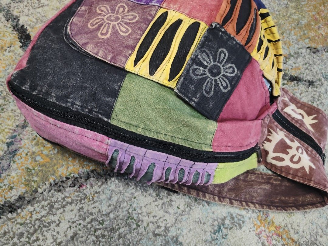 Boho Patchwork Backpack Bag (Category: Backpacks) located in Ipoh. Submitted by wajasstore (Listing ID 1447800903, Image 2). Description: - Funky patchwork backpack - Features colorful embroidered flowers and stripes - Zipper closure at the top - Adjustable straps for comfort - Ideal for everyday use or festivals - Unique and eye-catching design.