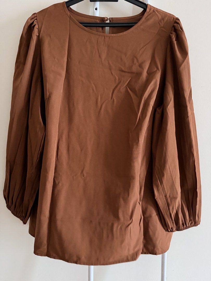 Brown Puff Sleeve Blouse with Back Button Detail (Category: Blouses) located in Kuala Lumpur. Submitted by jay_s (Listing ID 1447760421, Image 1). Description: - Elegant brown long-sleeve blouse - Stylish puff sleeves with elasticated cuffs - Classic round neckline - Convenient button closure at the back - Fabric with a subtle sheen Buy any 3pcs blouses for RM60.