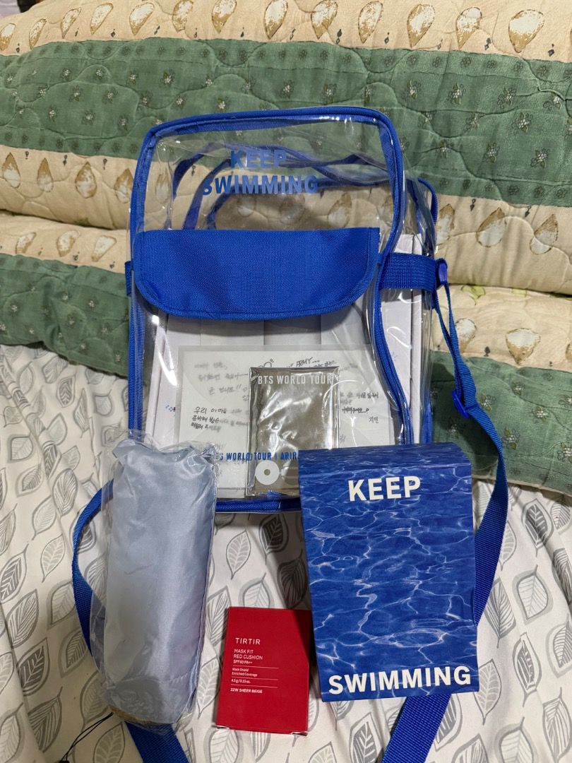 BTS IN BUSAN ARIRANG GIFT SET - DAY 2 (Category: K-Wave Merchandise) located in Manila. Submitted by declutterbyj_ (Listing ID 1447801141, Image 2). Description: - One clear sling bags available. -Clear blag with ‘KEEP SWIMMING’ print -OT7 photocards -Postcard with messages from BTS -2 towels (in box) -2 solid perfumes -Light blue umbrella with floater print -Laneige mask - Tirtir (22W Sheer Beige) RFS: extra only .
