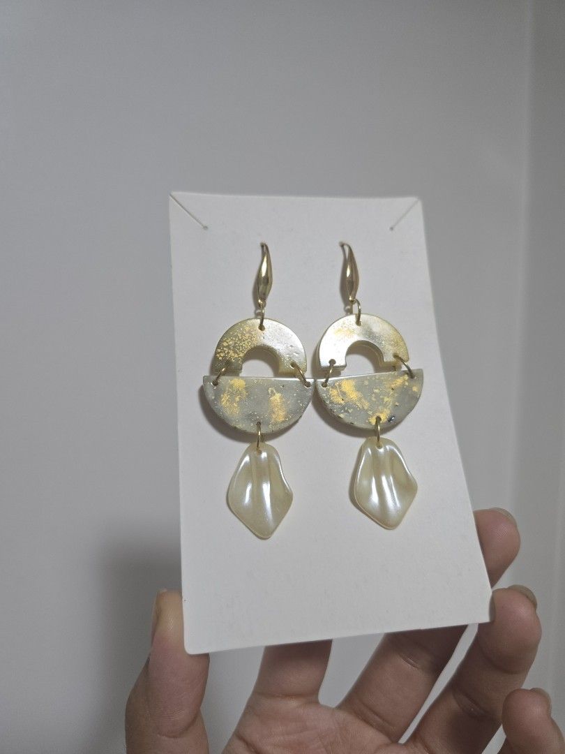 BUNDLE OF 2: Gold Tone Statement Earrings with Pearl Dangles (Category: Earrings) located in Pasig City. Submitted by callmemaf (Listing ID 1447681319, Image 3). Description: - Set of 2 unique gold tone earrings. - One pair features circular and pointed charms. - The other pair has half-circle charms with textured gold accents. - Both pairs have creamy, shell-shaped pearl dangles. - Ideal for dressing up any outfit. - gold plated ss316.