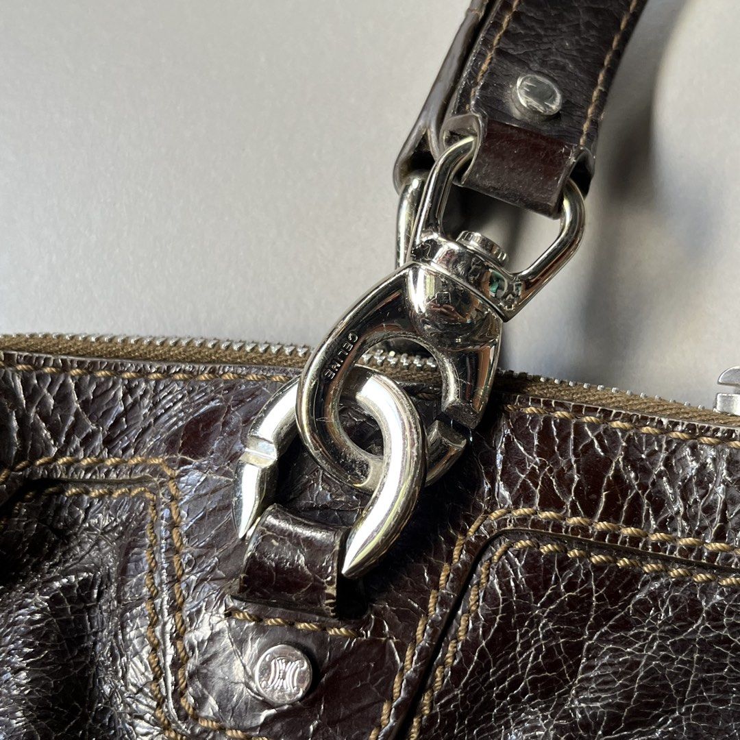Celine Dark Brown Leather Hand/Tote Bag (Category: Luxury Bags & Wallets) located in Cavite. Submitted by baguette_bae (Listing ID 1447768653, Image 3). Description: -Authentic Celine Bag -Crocodile Type Skin Leather - Dark brown leather Celine tote - Shiny, textured finish - Silver hardware details - Top handles with chain accents - Zipper closure - Some signs of wear on leather and edges - Perfect for stylish everyday use.