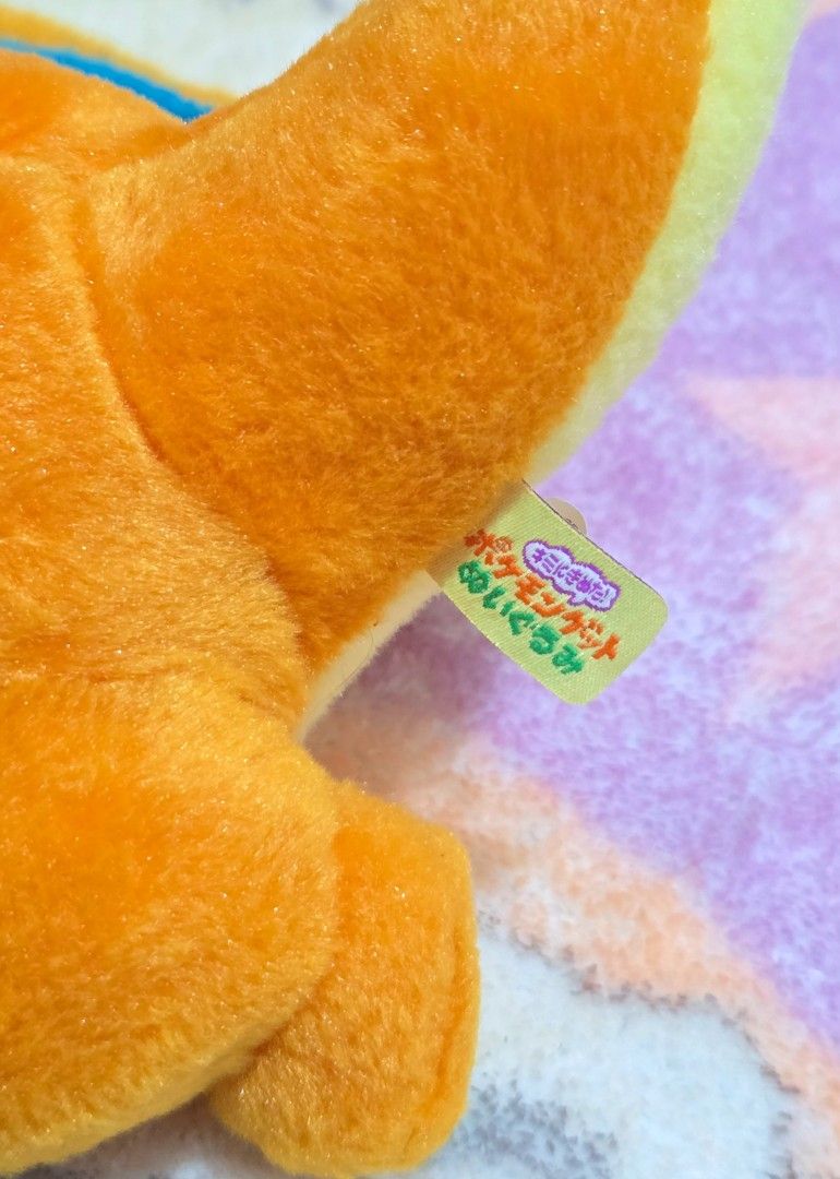 Charizard Pokemon Plush [T-ARTS] (Category: Plushies & Soft Toys) located in Paranaque City. Submitted by vanchris84 (Listing ID 1447829199, Image 3). Description: - Adorable Charizard plush toy - Vibrant orange body with iconic blue wings - Super soft and cuddly material - Ideal for any Pokemon enthusiast - Great for both display and playtime - Comes with original tag attached.