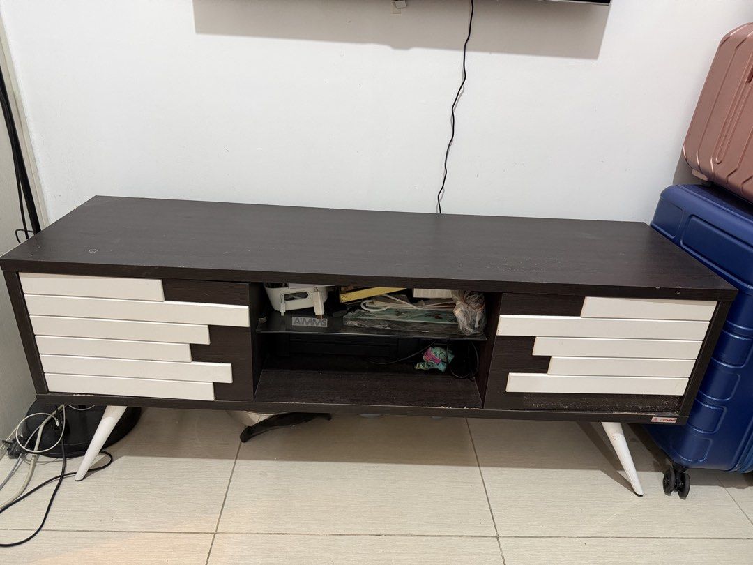 Console Table (Category: TV Consoles) located in Las Pinas. Submitted by shoptav (Listing ID 1447835331, Image 1). Description: Dimensions (approx.): * Length: 140 cm * Depth: 40 cm * Height: 77 cm * Used but still in good and sturdy condition. * No major flaws or structural issues. * One decorative white panel has come loose (shown in the photos) and just needs to be glued back in place. * Minor signs of wear from normal use. Price still negotia