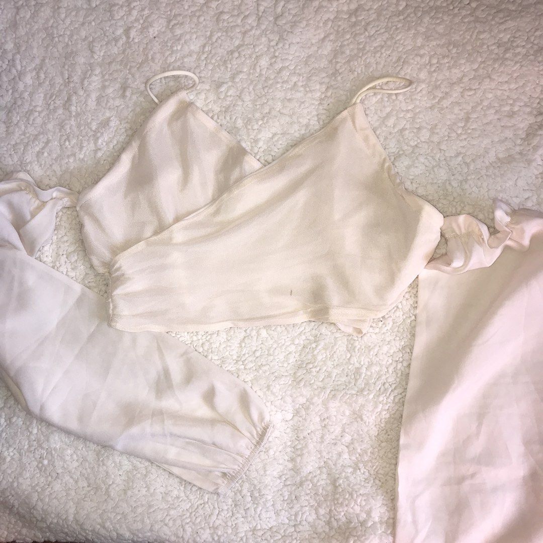 Cream Off-Shoulder Puff Sleeve Crop Top (Category: Blouses) located in Santa Cruz. Submitted by april_o. (Listing ID 1447743825, Image 1). Description: - Cream colored crop top - Off-shoulder design - Puff sleeves with ruffled detail - Thin spaghetti straps - Lightweight and flowy material - Versatile for night outs or casual days.