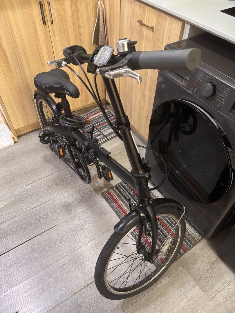 Dahon Route 20” Alloy Folding Bike (Category: Bicycles) located in Antipolo. Submitted by marcabeni_fox (Listing ID 1447696172, Image 2). Description: - Black folding bicycle - Equipped with mudguards on both wheels - Handlebars feature a bell and reflector - Comes with a chain lock - Easy to fold and store - Ideal for commuting or leisure rides - Ready for your next adventure!.