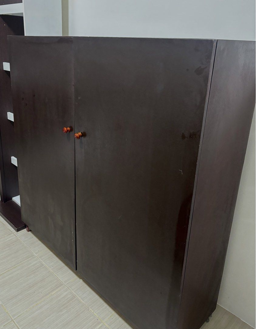 Dark Brown Two-Door Cabinet with Shelves (Category: Shelves, Cabinets & Racks) located in Manila. Submitted by thingsforsale07 (Listing ID 1447715498, Image 1). Description: - Dark brown cabinet - Two doors opening to three shelves - Plenty of storage space inside - Reddish-brown handles - Ideal for organizing belongings - Dimensions: Approx. [insert dimensions here if known].