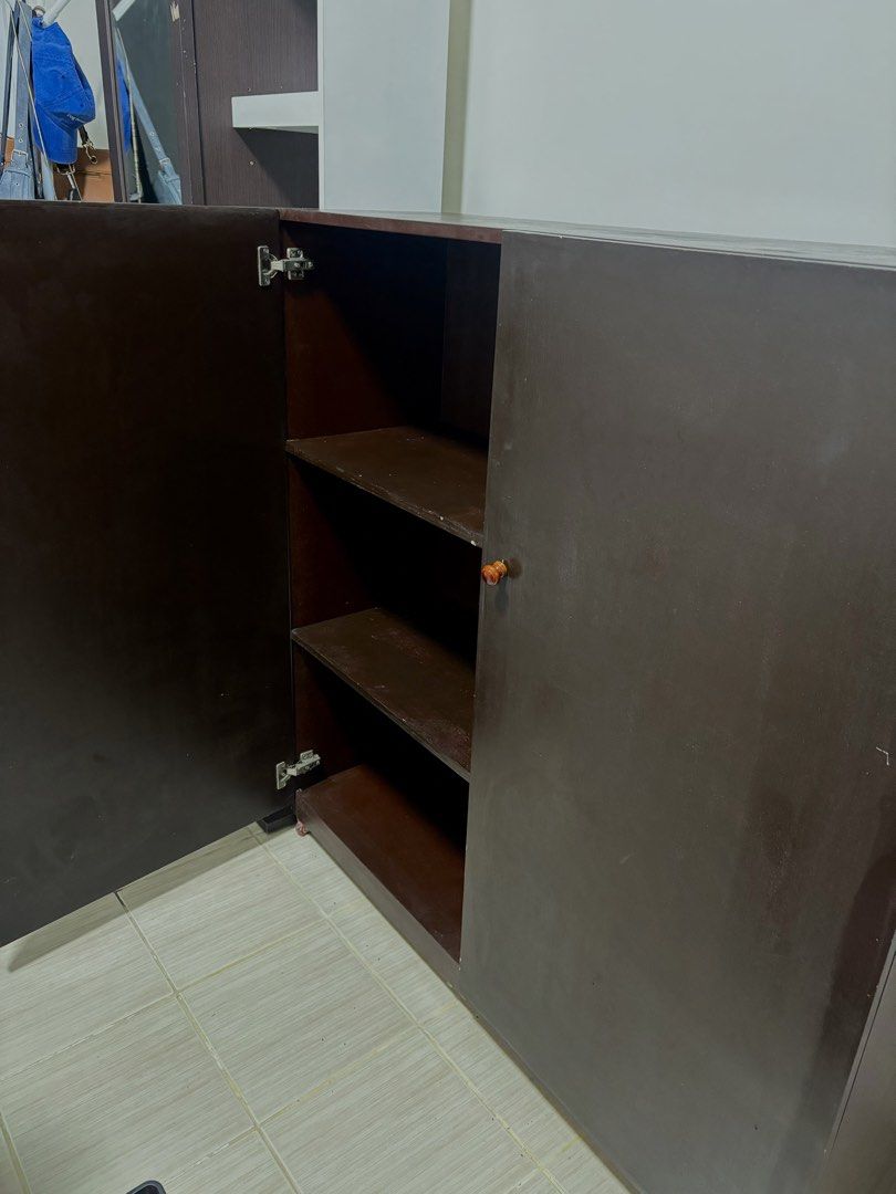 Dark Brown Two-Door Cabinet with Shelves (Category: Shelves, Cabinets & Racks) located in Manila. Submitted by thingsforsale07 (Listing ID 1447715498, Image 2). Description: - Dark brown cabinet - Two doors opening to three shelves - Plenty of storage space inside - Reddish-brown handles - Ideal for organizing belongings - Dimensions: Approx. [insert dimensions here if known].