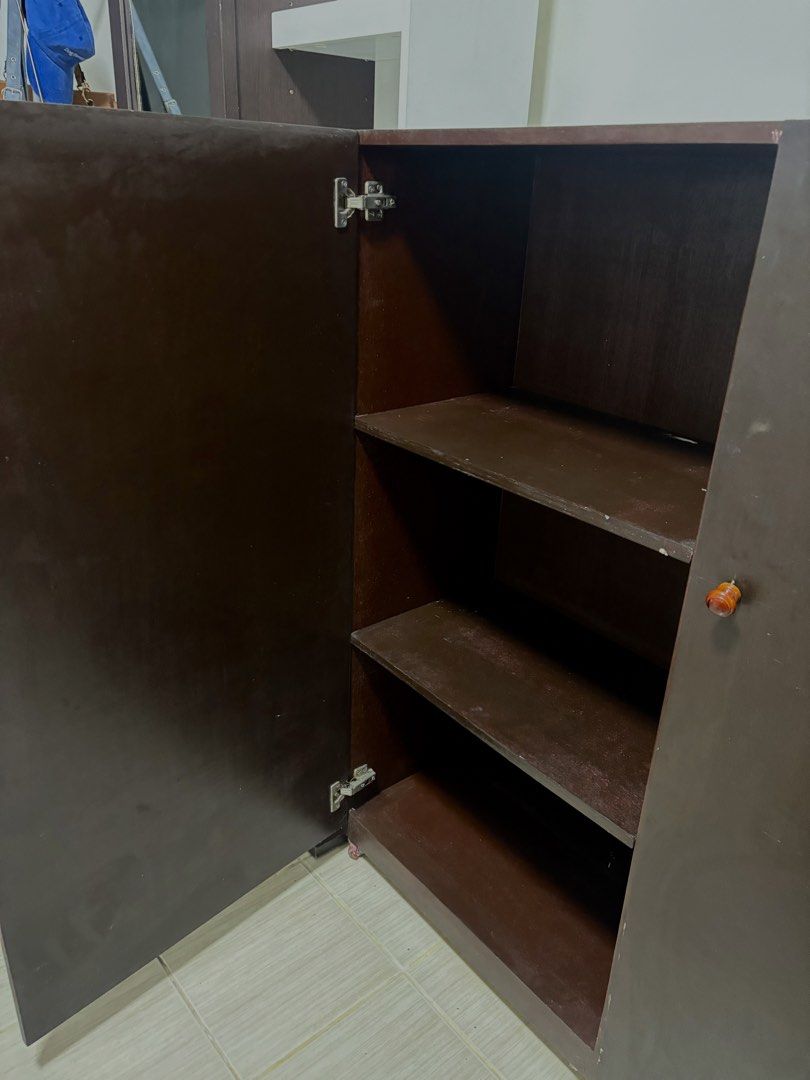 Dark Brown Two-Door Cabinet with Shelves (Category: Shelves, Cabinets & Racks) located in Manila. Submitted by thingsforsale07 (Listing ID 1447715498, Image 3). Description: - Dark brown cabinet - Two doors opening to three shelves - Plenty of storage space inside - Reddish-brown handles - Ideal for organizing belongings - Dimensions: Approx. [insert dimensions here if known].