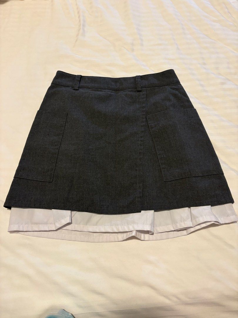Dark Grey Skirt with White Pleated Hem (Category: Skirts) located in Tacloban City. Submitted by khesslycoleen (Listing ID 1447840417, Image 1). Description: - Dark grey A-line skirt - Two functional front pockets - White pleated hem detail - School uniform aesthetic - Versatile for daily wear or costumes.