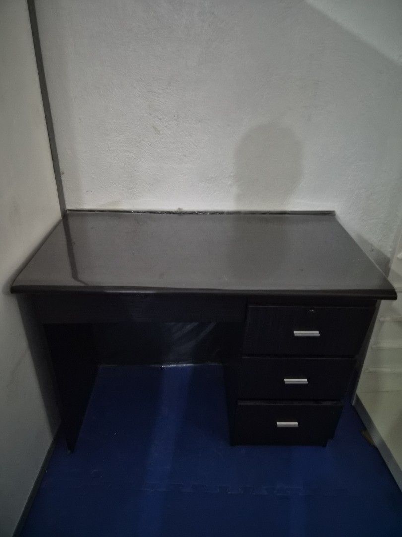 Dark Wood Desk with 3 Drawers, Study Table ,Office table (Category: Tables & Sets) located in Pasig City. Submitted by maidiem (Listing ID 1447764944, Image 2). Description: - Dark wood desk - Three drawers on the right side - Smooth and glossy top surface - Plenty of legroom underneath - Ideal for study or office use.