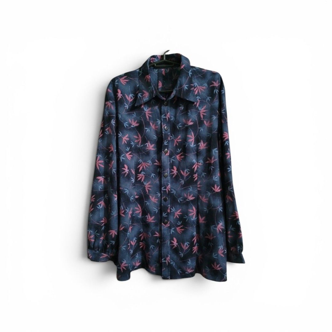 Floral Print Long Sleeve Shirt (Category: Blouses) located in Paranaque City. Submitted by mariam3842 (Listing ID 1413029326, Image 2). Description: - Dark blue long-sleeved shirt. - Features a floral pattern (pink and light blue). - Classic collar and button-down closure. - Can fit M-L sizes. - Buttoned cuffs. - Lightweight fabric. - Perfect for hot and warmer weather. "Note: The first photo is an AI-generated model for fit and styling reference