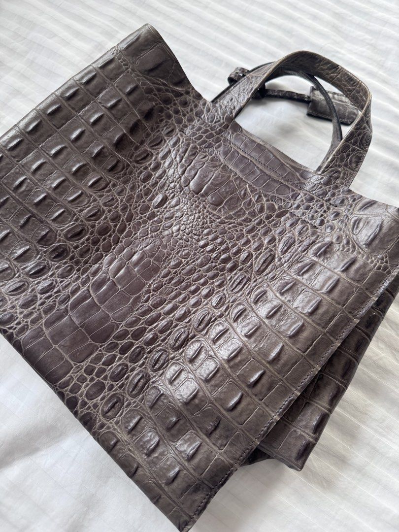 Furla Crocodile Embossed Leather Tote Bag (Category: Luxury Bags & Wallets) located in Makati City. Submitted by curatedandnearlynew (Listing ID 1447765757, Image 3). Description: - Croc embossed leather tote bag. - Color: dark gray - Features a secure internal zippered compartment. - Lined with a distinctive purple fabric showcasing a repeating logo. - Includes a charming small leather tag with an 'F' initial. - Ideal for everyday use or travel 
