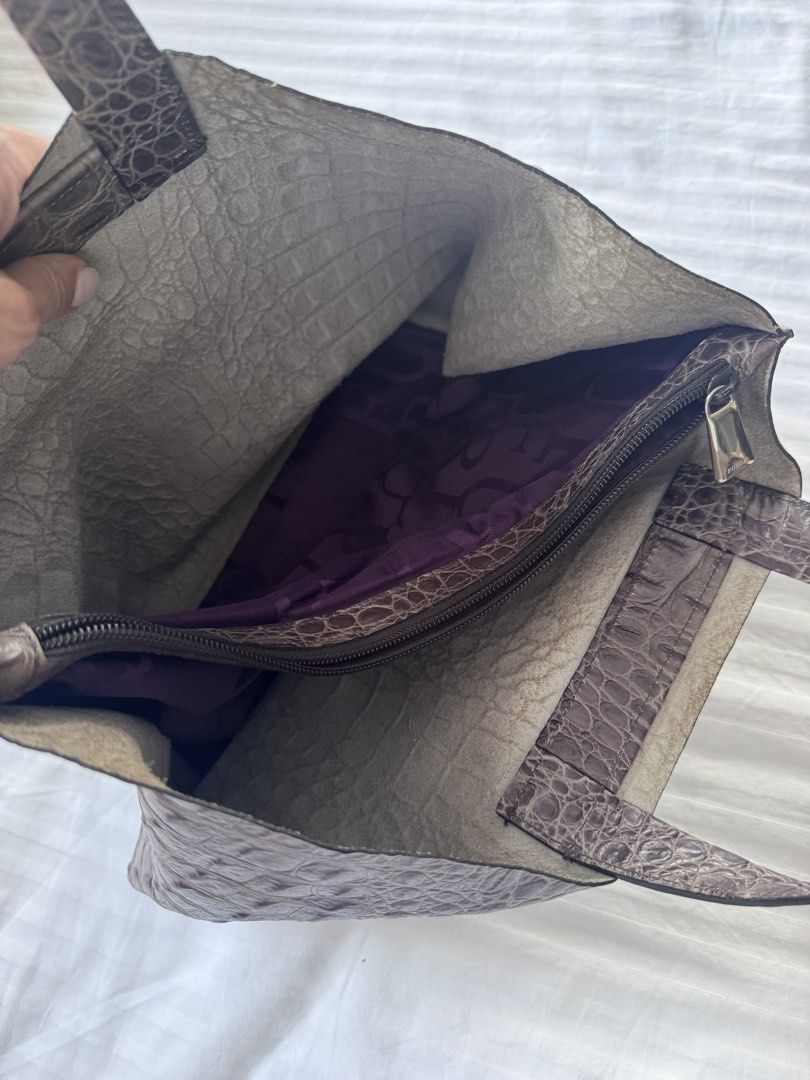 Furla Crocodile Embossed Leather Tote Bag (Category: Luxury Bags & Wallets) located in Makati City. Submitted by curatedandnearlynew (Listing ID 1447765757, Image 2). Description: - Croc embossed leather tote bag. - Color: dark gray - Features a secure internal zippered compartment. - Lined with a distinctive purple fabric showcasing a repeating logo. - Includes a charming small leather tag with an 'F' initial. - Ideal for everyday use or travel 