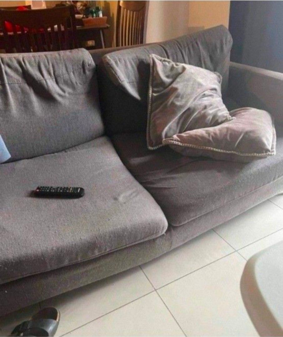 Gray Couch [With Issue] (Category: Sofas) located in Taguig. Submitted by belle8816 (Listing ID 1441596861, Image 2). Description: - Comfortable grey fabric sofa - Seats three people - Plush cushions and soft fabric - Modern design, fits most living rooms - Ideal for lounging or entertaining - With issue: wooden support underneath broken. need reinforcement/refurbishing. otherwise, good condition - Loc is Sheridan Mandaluyong.