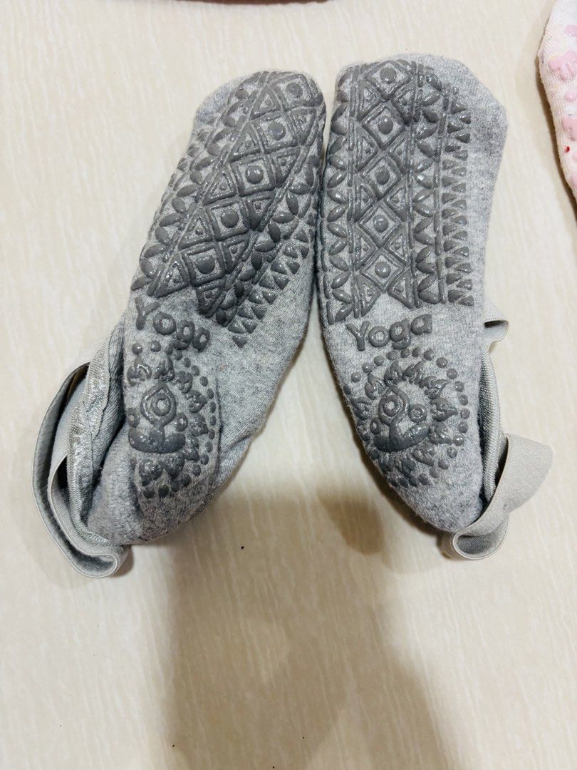 Grey Yoga Socks with Grips (Category: Socks & Tights) located in Manila. Submitted by yna_advocate (Listing ID 1447759184, Image 1). Description: No payment = unreserved Price is negotiable Please negotiate at a fair price since it is an original item Actual photos posted No issues Used once Lady owned RFS: decluttering - Grey yoga socks with enhanced grip soles - Diamond pattern and 'Yoga' text on soles for stability - Features a beautiful manda