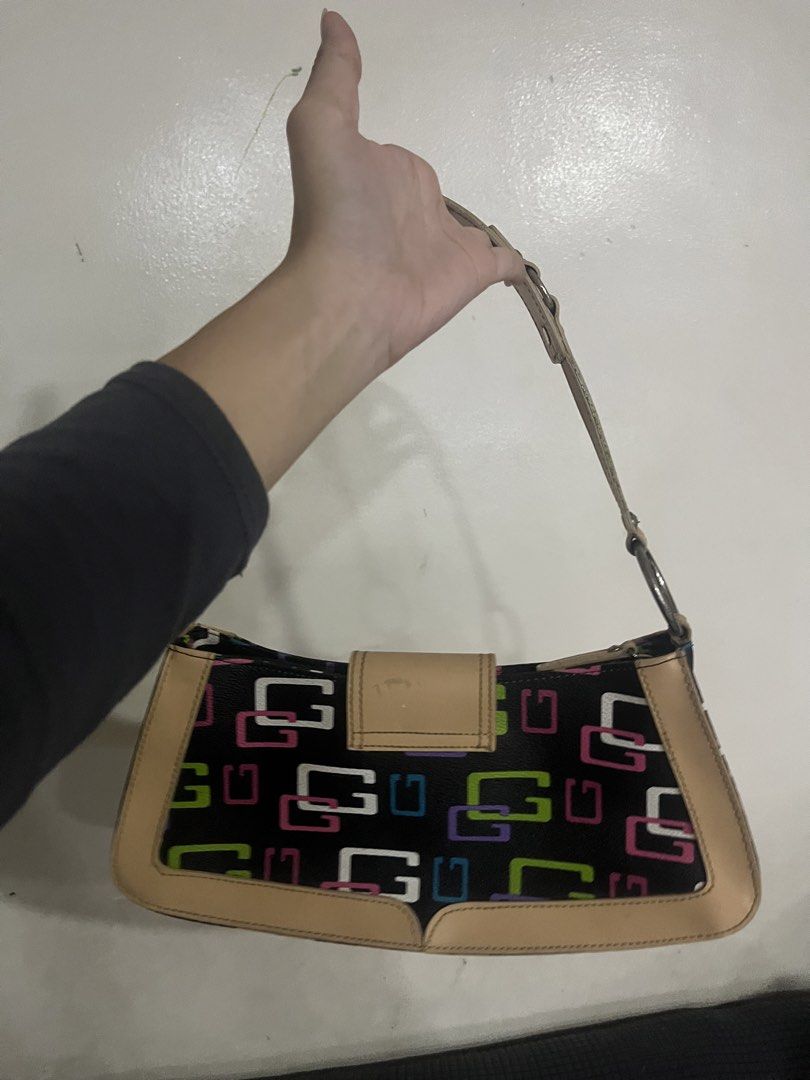 Guess Shoulder Bag - Black with Multi-Color G Logo (Category: Shoulder Bags) located in Manila. Submitted by declutbyal (Listing ID 1447749309, Image 2). Description: - Cute Guess shoulder bag - Black with iconic multi-colored G logo (pink, green, blue) - Tan trim and studded details - Adjustable strap for comfortable wear - Perfect for everyday use.