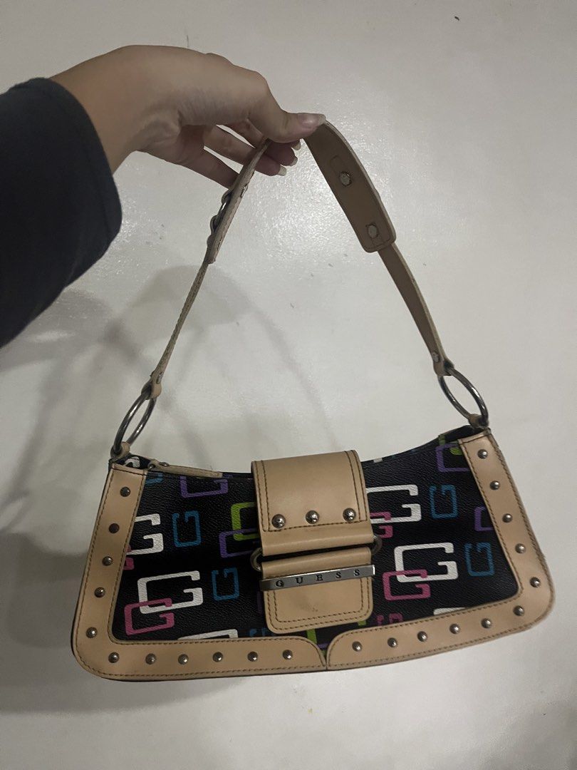 Guess Shoulder Bag - Black with Multi-Color G Logo (Category: Shoulder Bags) located in Manila. Submitted by declutbyal (Listing ID 1447749309, Image 1). Description: - Cute Guess shoulder bag - Black with iconic multi-colored G logo (pink, green, blue) - Tan trim and studded details - Adjustable strap for comfortable wear - Perfect for everyday use.