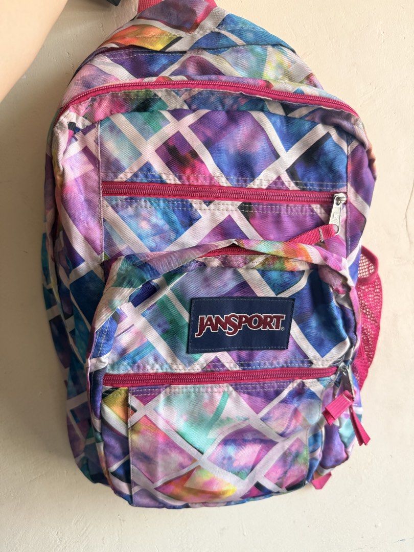 Jansport Backpack - Colorful Geometric Galaxy Print (Category: Backpacks) located in Paranaque City. Submitted by sweetiesarah01 (Listing ID 1447795644, Image 1). Description: - Eye-catching Jansport backpack with a vibrant geometric galaxy print. - Features multiple zippered compartments for easy organization. - Adjustable straps for a comfortable fit. - Ideal for school, college, or everyday adventures..
