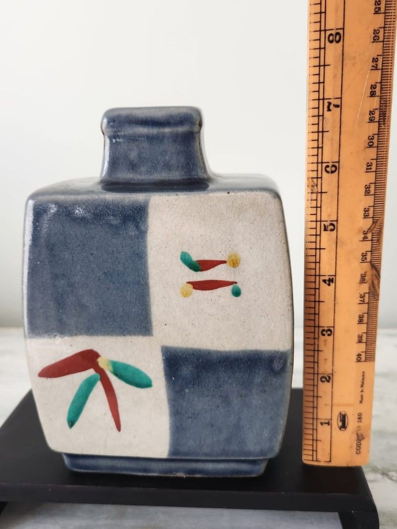 Japanese Style Ceramic Vase with Blue and White Checkered Design (Category: Vases & Decorative Bowls) located in Kuala Lumpur. Submitted by gentlepenguin.6b8aad (Listing ID 1447779007, Image 2). Description: - Unique square ceramic vase, approximately 5 inches tall. - Features a classic blue and white checkered pattern. - Adorned with hand-painted red, green, and yellow floral accents. - Rectangular opening, ideal for small floral arrangements. -