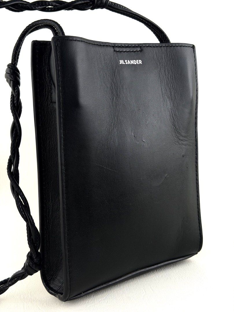 JIL SANDER Tangle Crossbody bag (Category: Luxury Bags & Wallets) located in Manila. Submitted by luvluxe.mnl (Listing ID 1447817899, Image 2). Description: Small size- fits iphone promax Sooo nice!!! So chic & edgy Perf for everyday Unisex With signs of use seen on picture but overall in very good condition—no functionality issue Still presentable Srp online is 27k+ php.