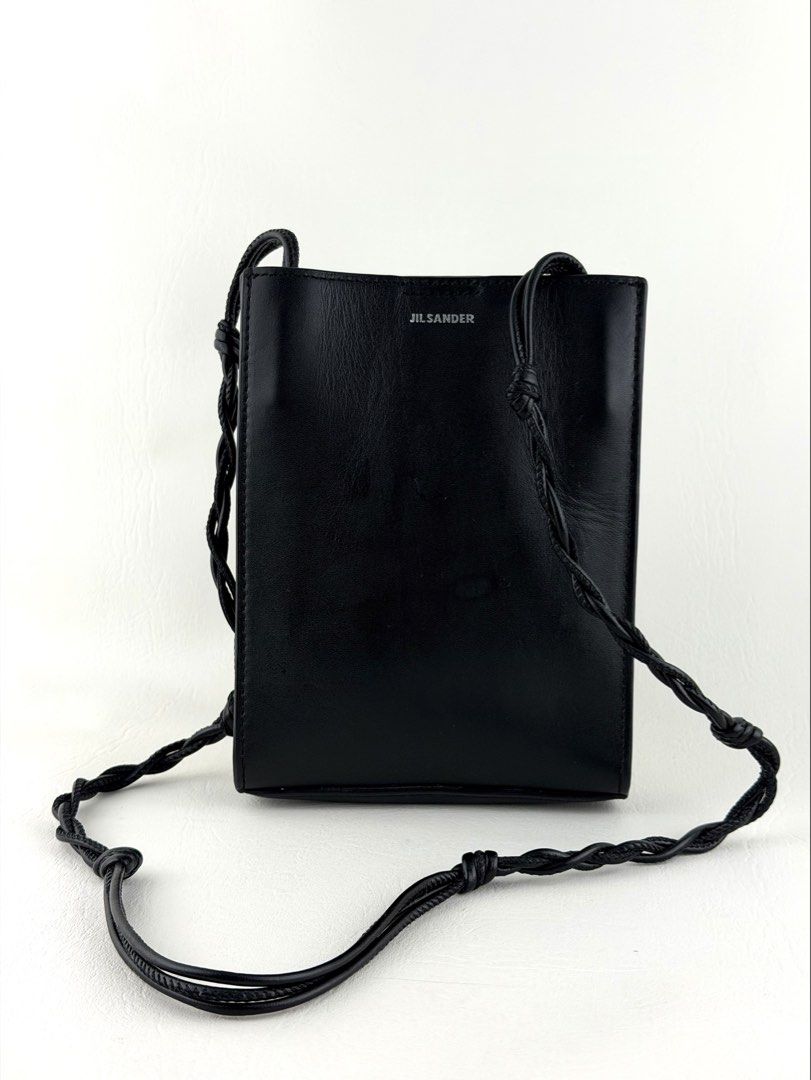 JIL SANDER Tangle Crossbody bag (Category: Luxury Bags & Wallets) located in Manila. Submitted by luvluxe.mnl (Listing ID 1447817899, Image 1). Description: Small size- fits iphone promax Sooo nice!!! So chic & edgy Perf for everyday Unisex With signs of use seen on picture but overall in very good condition—no functionality issue Still presentable Srp online is 27k+ php.
