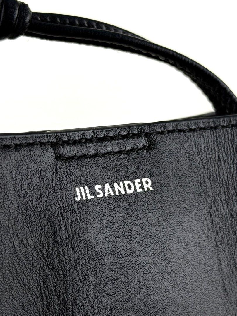 JIL SANDER Tangle Crossbody bag (Category: Luxury Bags & Wallets) located in Manila. Submitted by luvluxe.mnl (Listing ID 1447817899, Image 3). Description: Small size- fits iphone promax Sooo nice!!! So chic & edgy Perf for everyday Unisex With signs of use seen on picture but overall in very good condition—no functionality issue Still presentable Srp online is 27k+ php.