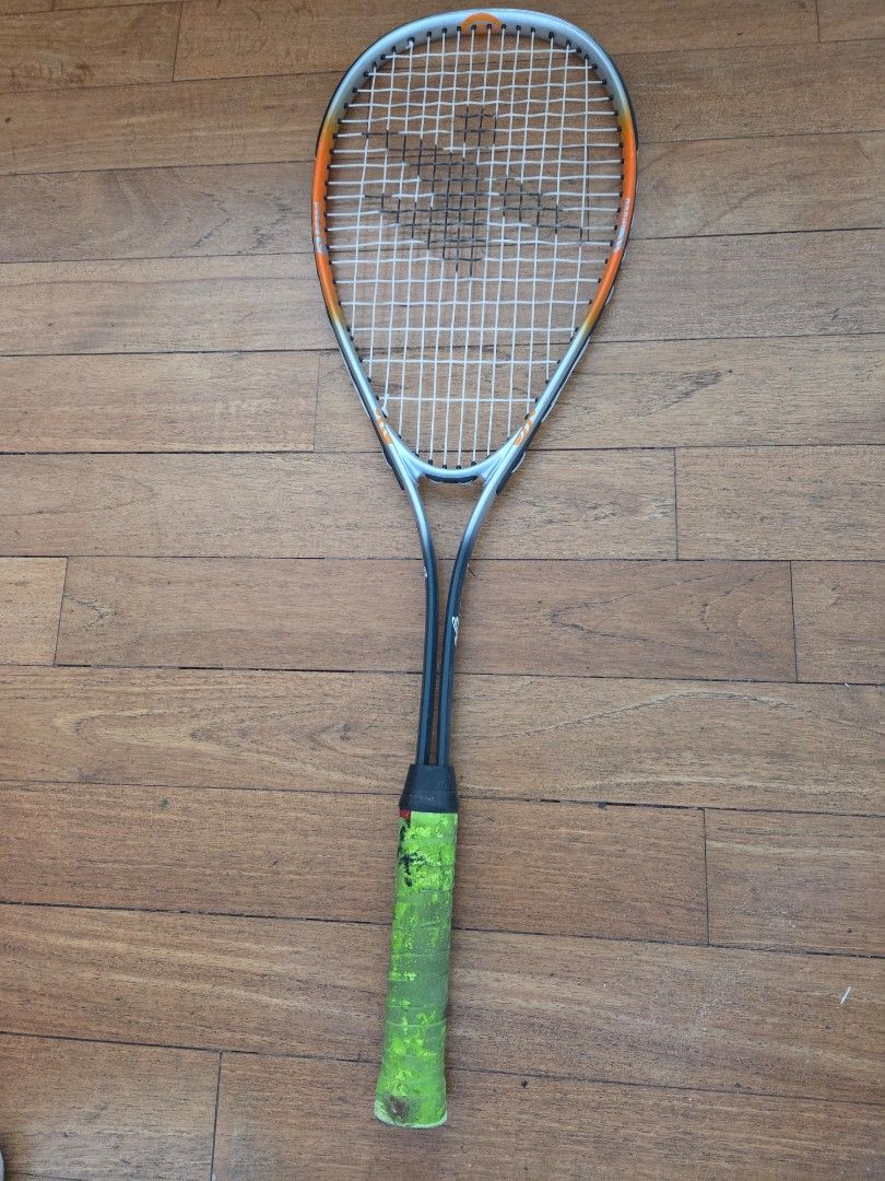 Squash Racket (Category: Racket & Ball Sports) located in Singapore. Submitted by babyfish2016 (Listing ID 1447686178, Image 1). Description: - squash racket - Bright green grip with signs of use - Frame features orange and grey accents - Ready for your next game.