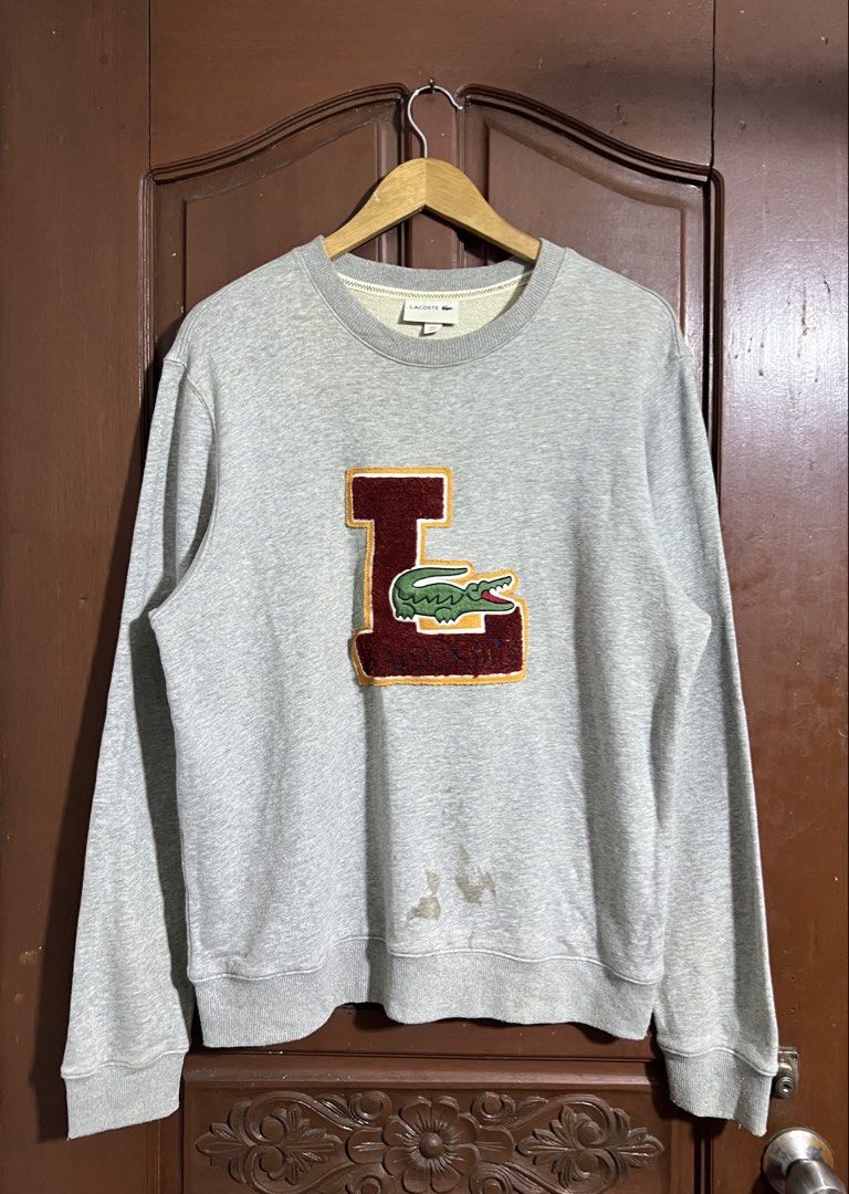 Lacoste Gray Embroidered Patch Design Pull Over Sweater (Category: Coats, Jackets and Outerwear) located in Manila. Submitted by thriftpoint99 (Listing ID 1447846198, Image 1). Description: 23x27 Issue stain fresh from bale. Not yet washed Good condition.