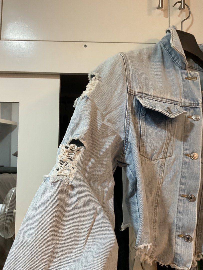 Light Wash Ripped Cropped Denim Jacket (Category: Coats, Jackets and Outerwear) located in Bulacan. Submitted by periwinkle_21 (Listing ID 1447868315, Image 2). Description: CLEARANCE SALE MGA SISSY!❤️ for declutter purposes only - Light wash denim jacket - Cropped style with ripped design - Button-up front - Two chest pockets - Ideal for casual layering over tops or dresses - NO ISSUE - Medium to Semi Large.