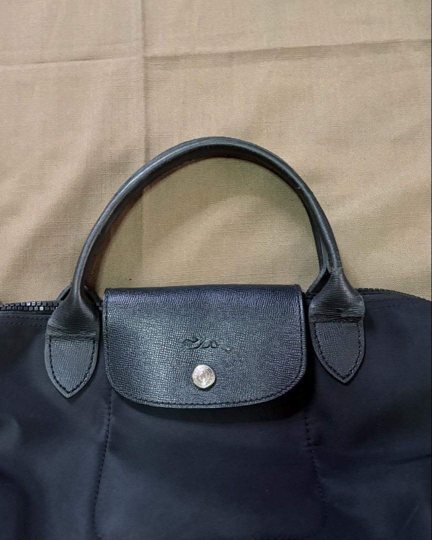 Longchamp Le Pliage Neo Small in Black (Category: Shoulder Bags) located in Quezon City. Submitted by xmanarchive (Listing ID 1447711126, Image 2). Description: - 8/10 condition; Leather handles have visible wear/chipping from normal use (shown in photos) - Nylon body with leather flap and handles - Needs cleaning Send an offer and let’s talk about it.