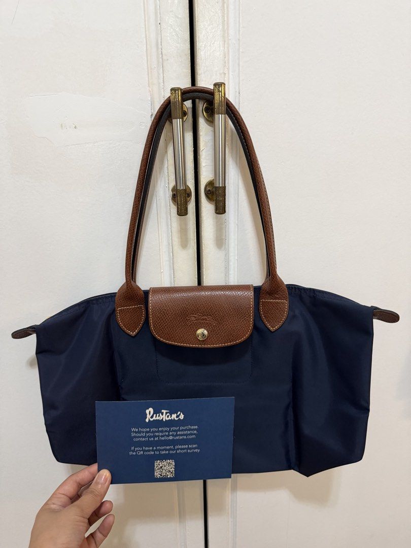 Longchamp Le Pliage Navy Blue Medium (Category: Luxury Bags & Wallets) located in Quezon City. Submitted by lemariesuing (Listing ID 1447717348, Image 2). Description: 100% original bought from Rustans reason for selling: decluttering with Longchamp Ziplock bag no flaws and issues, very clean Talipapa Quezon City area seller Shipping only thru lalamove or grab in areas accessible from Quezon City.