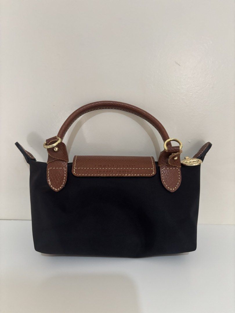 Longchamp Paris Le Pliage Cuir Small Top Handle Bag (Category: Luxury Bags & Wallets) located in Quezon. Submitted by chelvtann (Listing ID 1447727062, Image 2). Description: - Authentic Longchamp Le Pliage Cuir small top handle bag - Color: Black with brown leather trim and handles - Features a detachable shoulder strap - Made in France - Ideal for everyday use or travel.