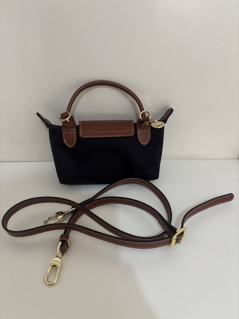 Longchamp Paris Le Pliage Cuir Small Top Handle Bag (Category: Luxury Bags & Wallets) located in Quezon. Submitted by chelvtann (Listing ID 1447727062, Image 3). Description: - Authentic Longchamp Le Pliage Cuir small top handle bag - Color: Black with brown leather trim and handles - Features a detachable shoulder strap - Made in France - Ideal for everyday use or travel.