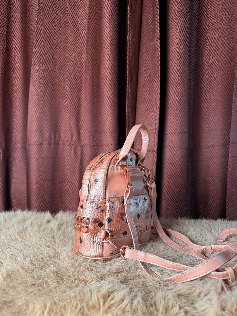 MCM Rose Gold Monogram Mini Backpack (Category: Backpacks) located in Manila. Submitted by femnlofficial (Listing ID 1447881472, Image 2). Description: - Super cute MCM mini backpack - Rose gold color with classic monogram print - Front zip pocket - Adjustable straps - Small and compact, fits essentials - Great for everyday use or a night out.