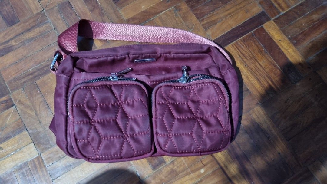 Michaela Maroon Quilted Crossbody Bag with Adjustable Strap (Category: Cross-body Bags) located in Manila. Submitted by yellowfaust (Listing ID 1447851263, Image 1). Description: - Stylish maroon crossbody bag - Features two quilted front pockets - Main compartment with secure zip closure - Additional back pocket with zip closure - Adjustable strap for comfortable wear - Ideal for everyday use - Spacious interior for your essentials Flaws: Zipper